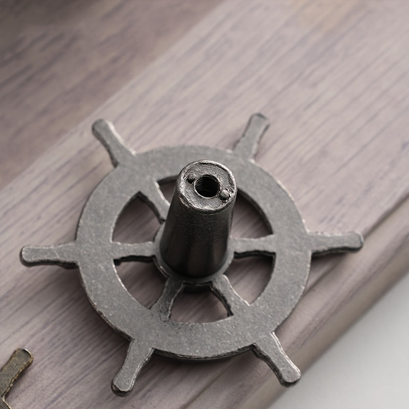 15-piece set of antique bronze ship helm cabinet handles featuring a vintage maritime design for a coordinated nautical décor look.