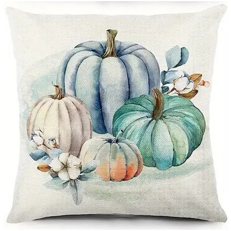 Pillow cover with cluster of teal, blue, and cream pumpkins with soft botanical accents.