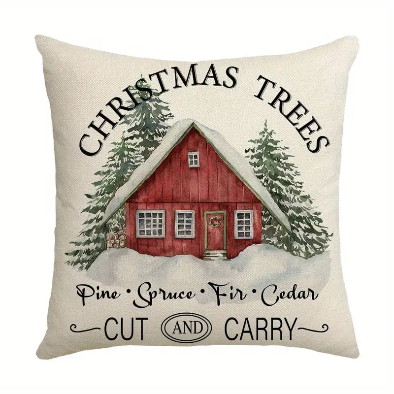 Pillow cover with Christmas trees text, a red cabin, and evergreen trees with cut and carry wording on a neutral background