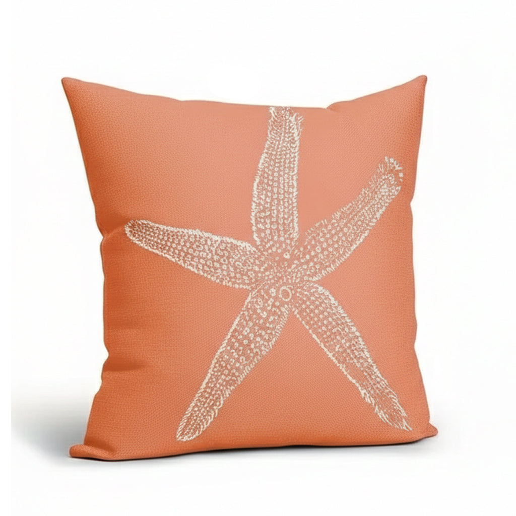 Coral-colored linen pillow cover featuring a white starfish design on a textured fabric background.