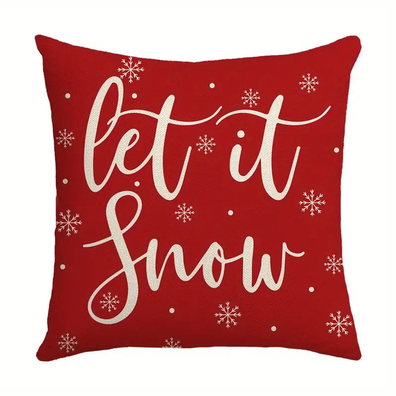 Red Let It Snow Christmas pillow cover with white script lettering and snowflakes