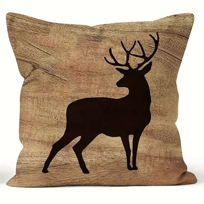 Square pillow cover featuring a dark deer silhouette against a warm wood-grain background.