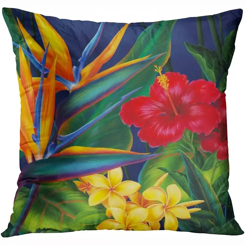 Decorative pillow cover featuring red hibiscus, bird of paradise, and yellow plumeria flowers on a deep blue background.
