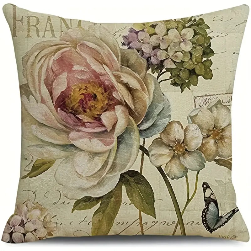 Decorative 18x18 linen pillow cover featuring a vintage-style peony and hydrangea arrangement with greenery and a butterfly accent on a neutral script background.