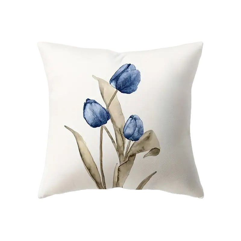 Illustrative 18x18 inch pillow cover featuring three watercolor-style blue Tulips with flowing tan leaves on a white background, styled on a sofa for spring décor – Coastal Pillows Plus.