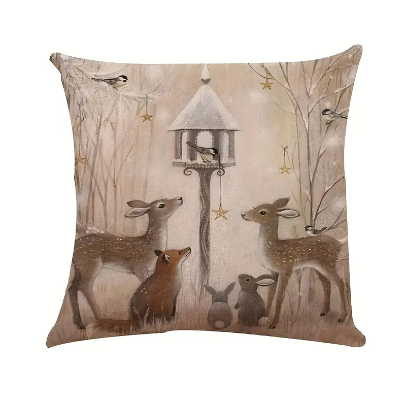 Winter pillow cover featuring deer and woodland animals gathered in a winter forest scene with bird feeder.