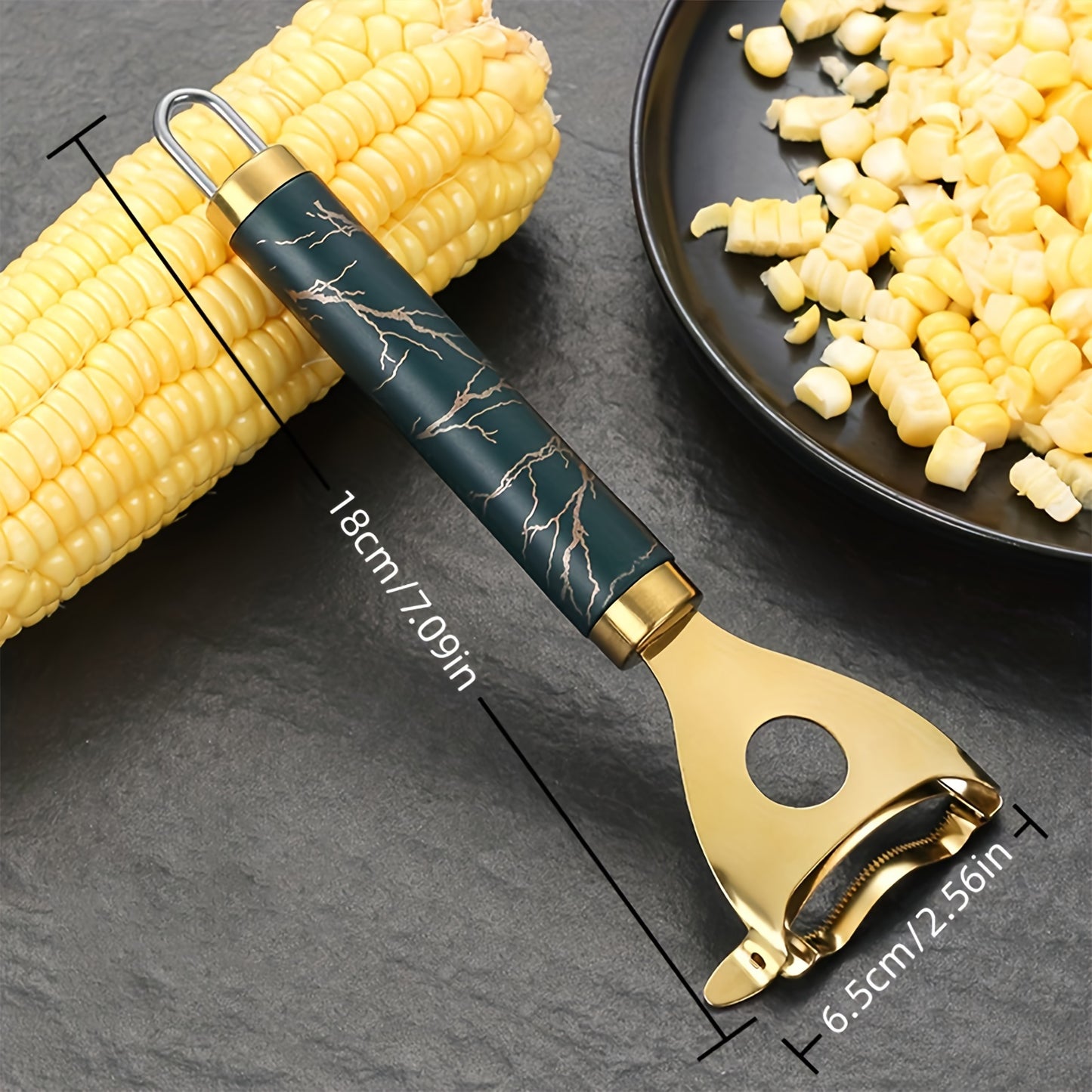 Heavy-duty gold-tone corn stripper featuring a navy marble-patterned handle for a functional and sophisticated kitchen décor.