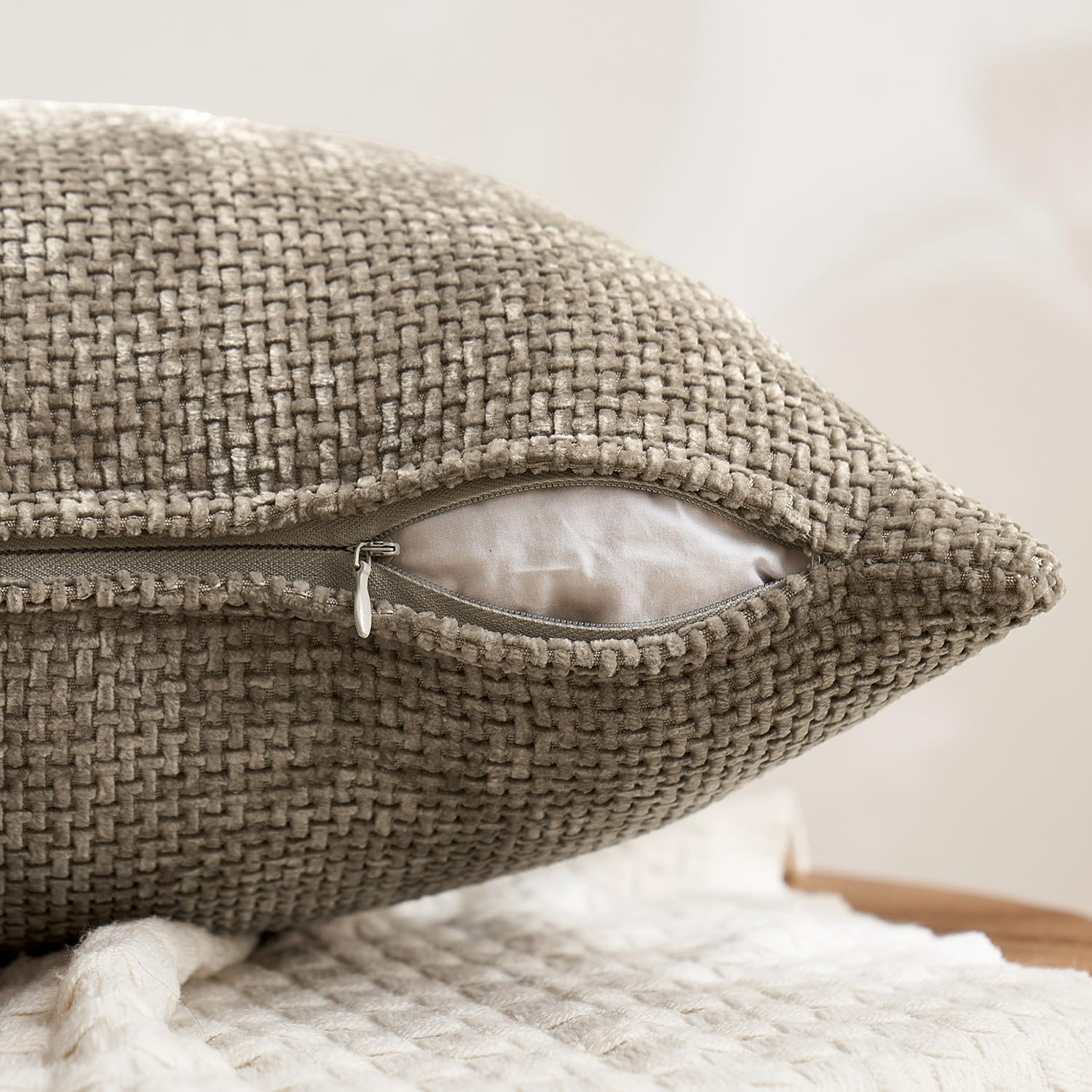 Chenille woven 18x18 inch pillow covers, 4-piece set, in warm taupe, slate grey, pebble, and true black, linen-textured and styled on a sofa for home décor – Coastal Pillows Plus.