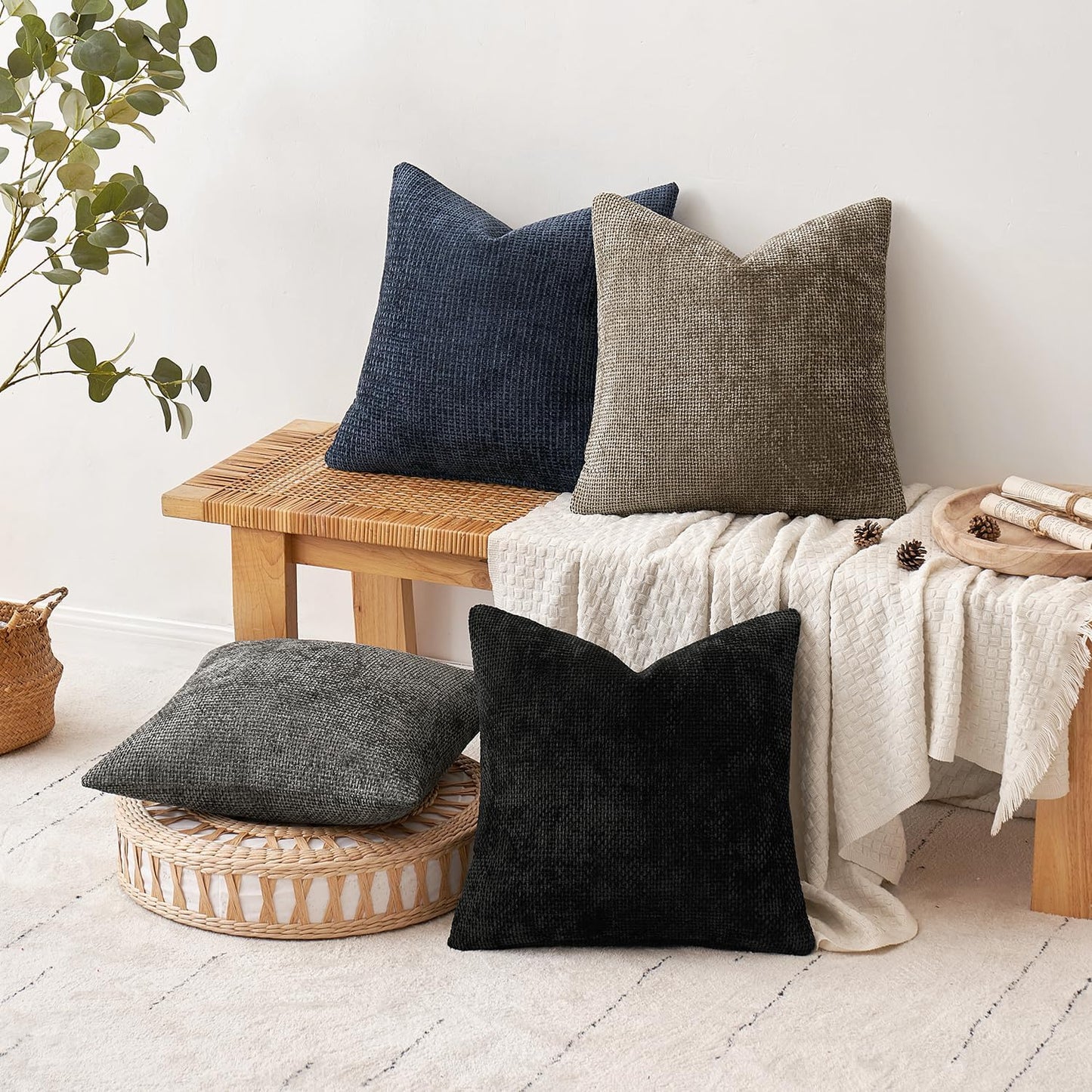 Naturally Toned 18x18 inch pillow covers in Warm Taupe, Slate Grey, Pebble, and Black showing a dense woven grid pattern, styled on a neutral sofa for coastal décor – Coastal Pillows Plus.