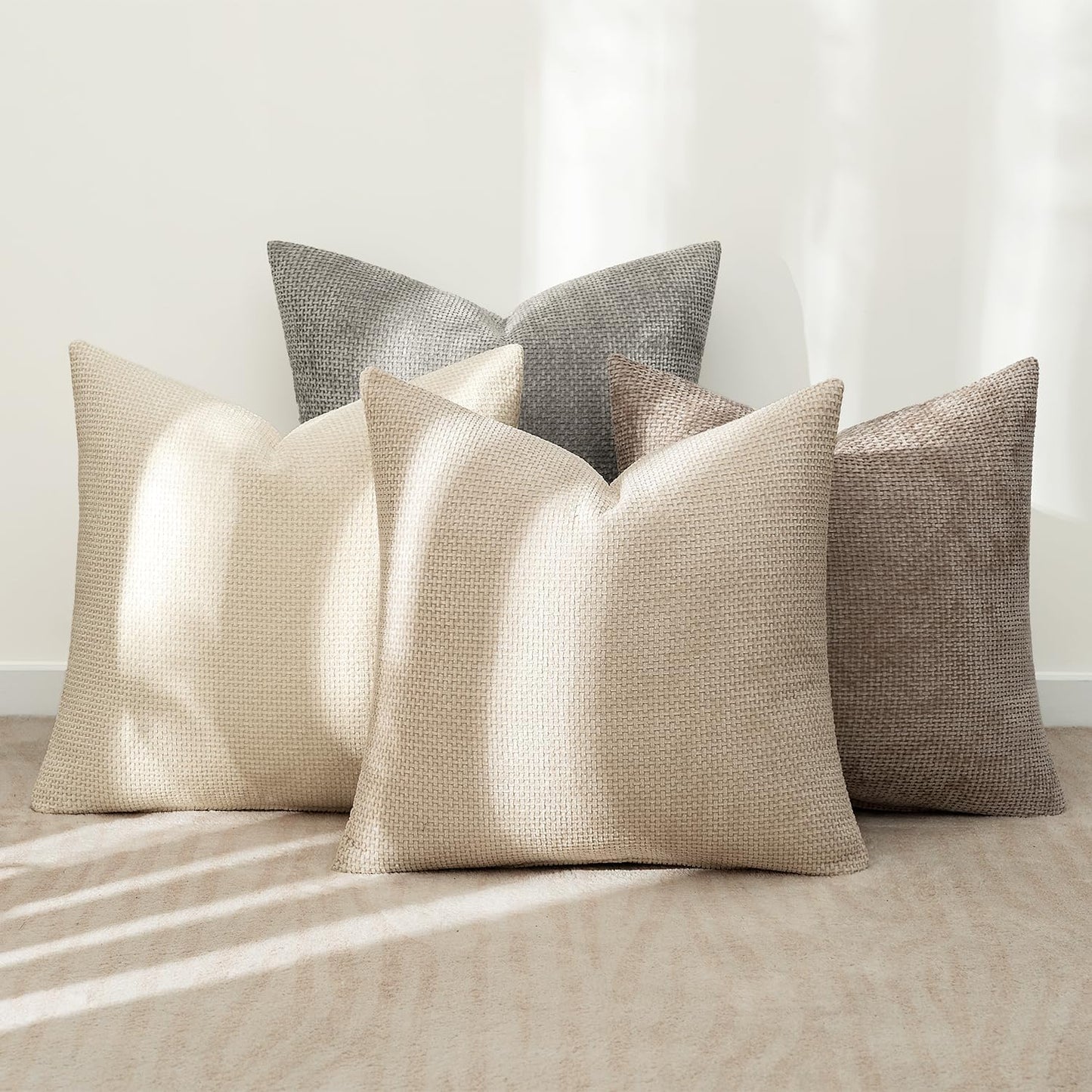 Atmospheric 18x18 inch pillow covers in sandstone, driftwood, taupe, and slate showing a dense woven grid pattern for coastal décor – Coastal Pillows Plus.