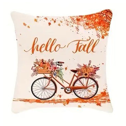 Linen pillow cover with “hello fall” script above a bicycle decorated with autumn florals and leaves.