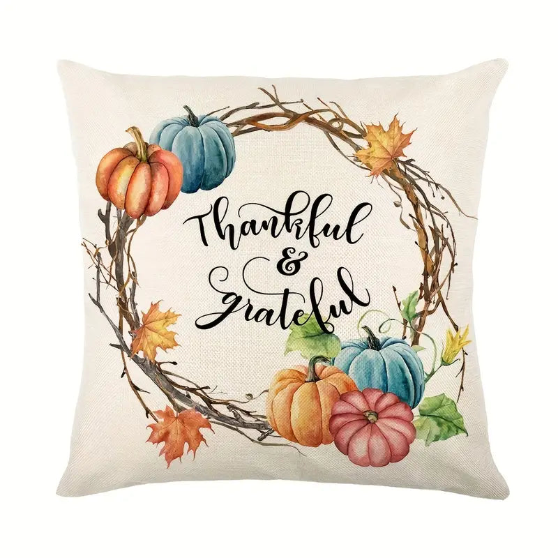 Linen pillow cover with Thankful & Grateful text centered in wreath with pumpkins and autumn leaves.