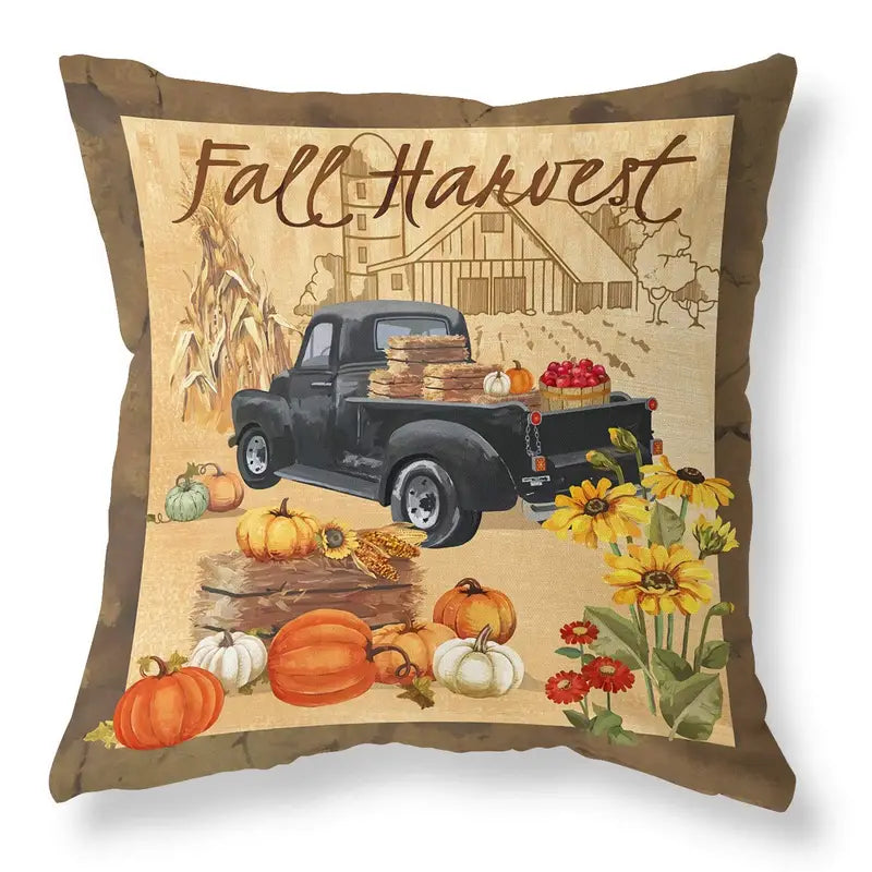 Pillow cover with Fall Harvest text above black vintage truck with pumpkins, hay bales, barn, and sunflowers.