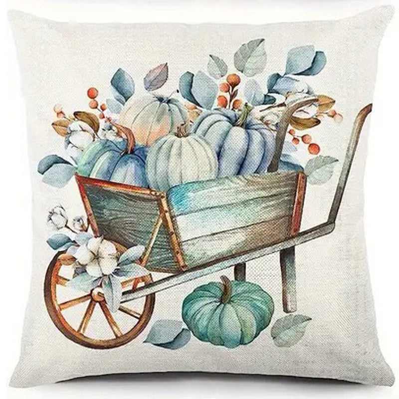 Pillow cover with rustic wheelbarrow filled with teal and cream pumpkins and cotton stems.