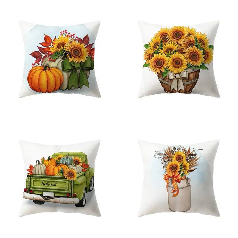Four pillow covers with sunflowers, pumpkins, harvest truck, and sunflower arrangements in warm fall tones.