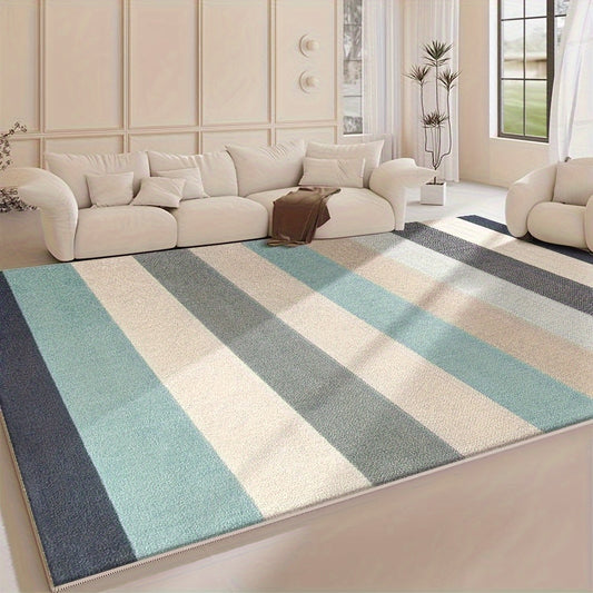 Coastal area rug featuring soft blue and green horizontal stripes with a wave-inspired pattern on a neutral background.