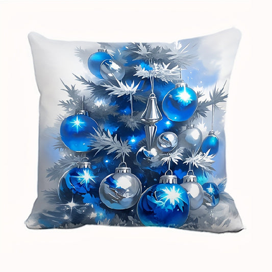 White pillow cover with blue and silver Christmas ornaments hanging on a decorated tree