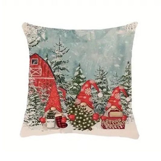Christmas pillow cover with gnomes in a snowy barn scene with trees and winter decorations.