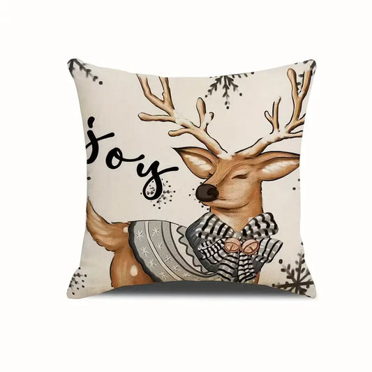 Outdoor Christmas deer pillow cover with winter scarf, snowflakes, and the word joy on a neutral background