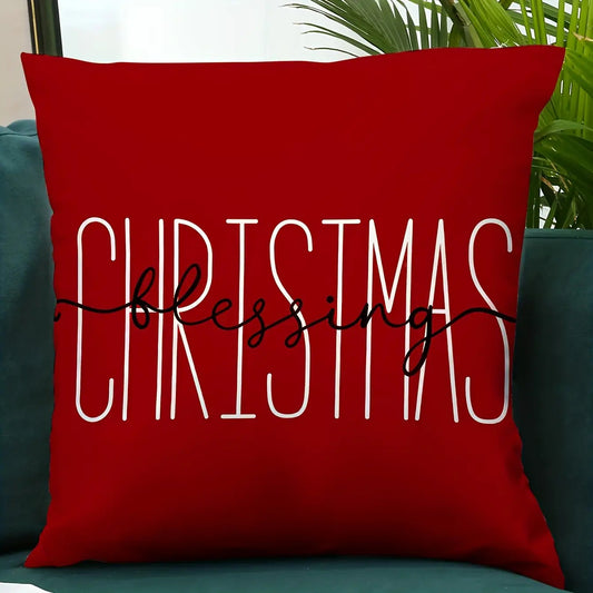 Red pillow cover with the word Christmas in large white lettering