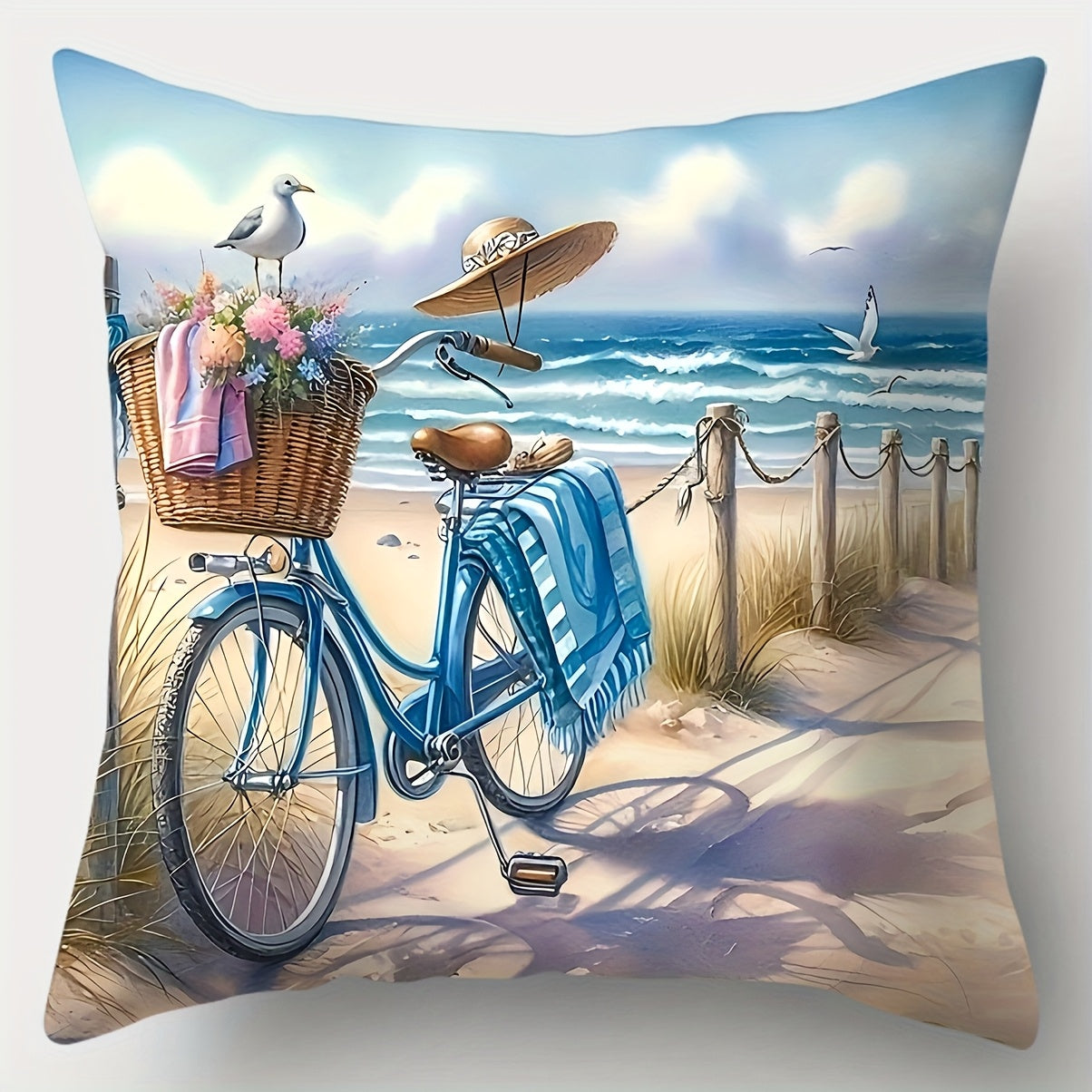 Coastal pillow cover featuring a blue bicycle with basket on a sandy path near the ocean with surfboard and seaside scenery.