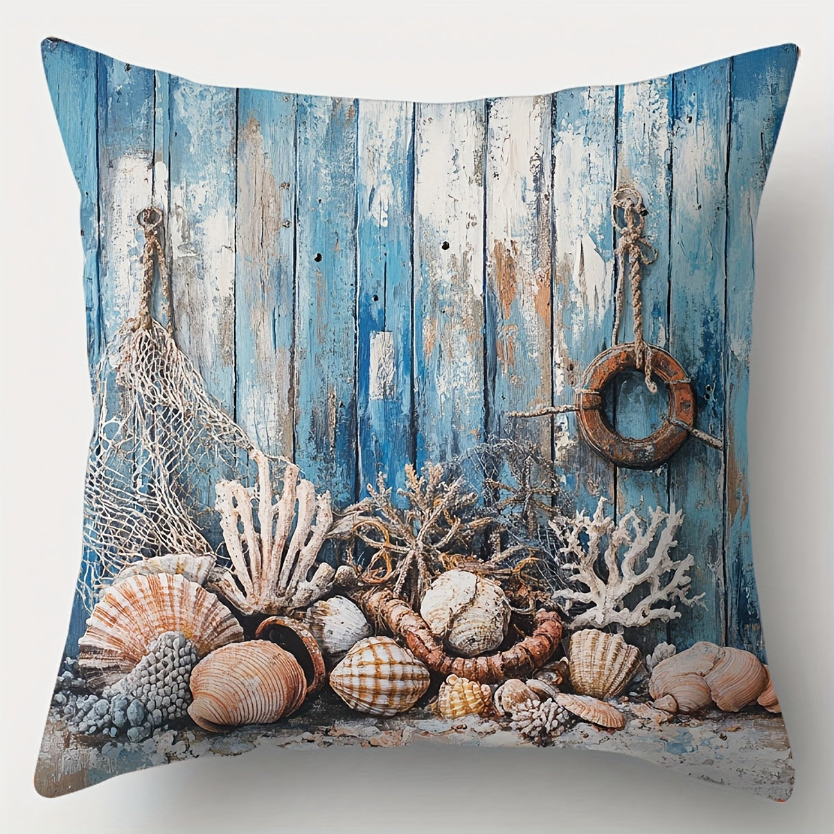 Coastal pillow cover featuring seashells, coral, fishing net, and rope arranged against a weathered blue wood background.