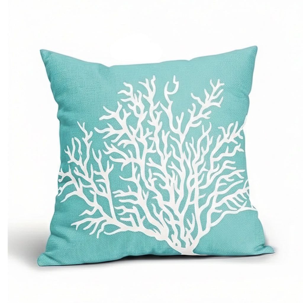 Cerulean blue linen pillow cover featuring a white branching coral design on textured fabric background.