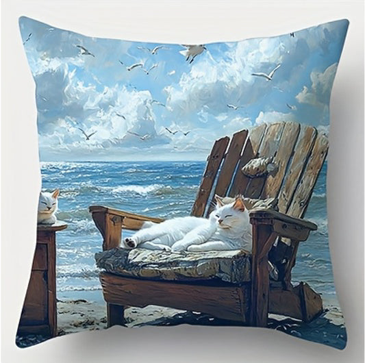 Coastal pillow cover featuring a white cat resting on a cushioned beach chair with ocean waves and flying seabirds in the background.