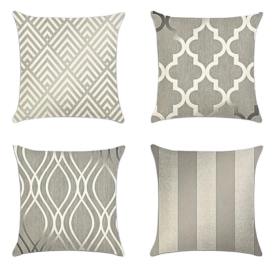 A collection of four neutral linen-blend pillow covers featuring Art Deco chevron, metallic quatrefoil, modern ogee wave, and shimmering wide stripe patterns - Coastal Pillows Plus