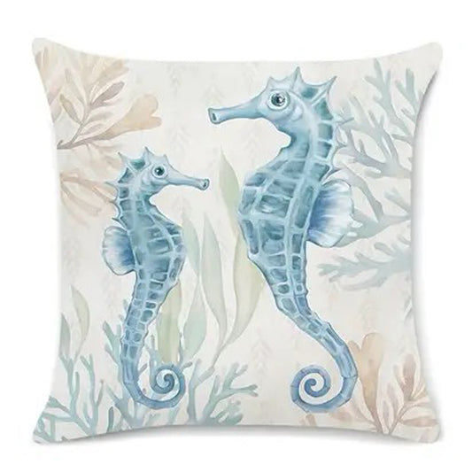 Coastal pillow cover featuring two illustrated seahorses with sea plants in soft blue and neutral tones.