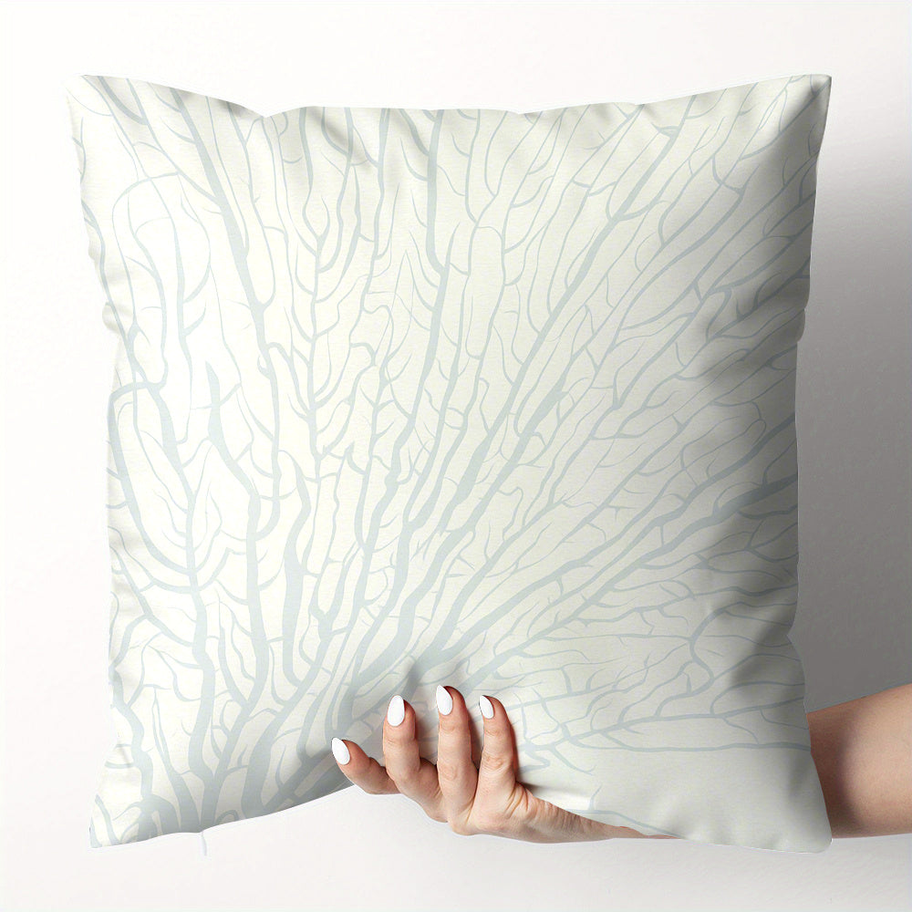 White pillow with subtle pattern held by a hand against a light gray background