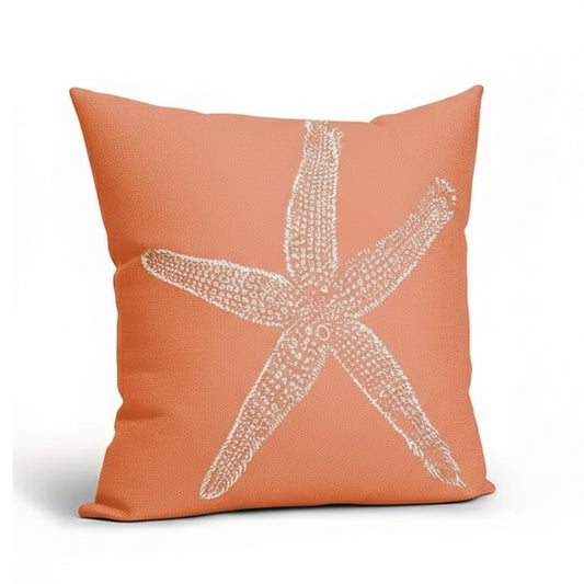 Coral-colored linen pillow cover featuring a white starfish design on a textured fabric background.