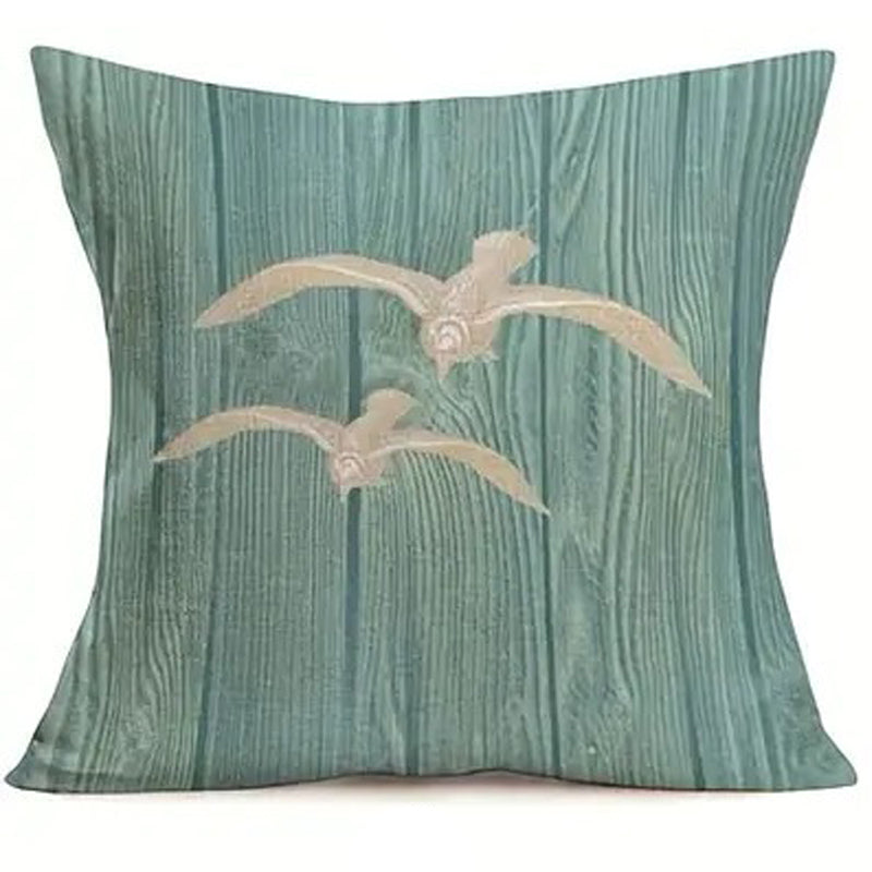 Pillow cover featuring two cream seabirds in flight on a teal wood grain-style background.