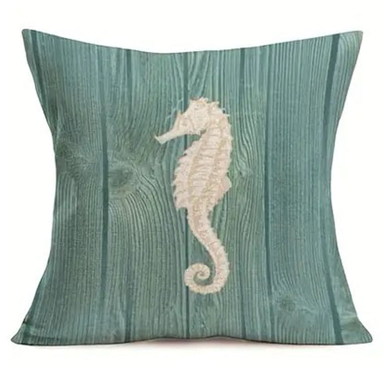 Pillow cover featuring a cream seahorse silhouette on a teal wood grain-style background.