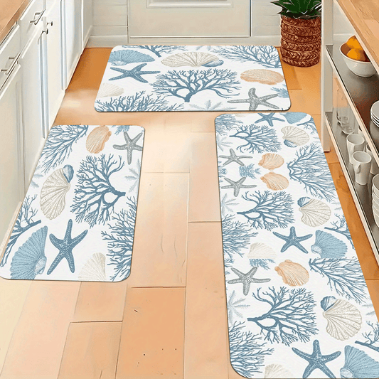 Coastal kitchen mat or runner featuring coral reef branches, starfish, and seashell patterns in blue and sand tones.