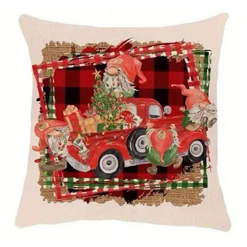 Farmhouse Christmas pillow cover featuring a gnome driving a red truck with a Christmas tree on a buffalo plaid background.