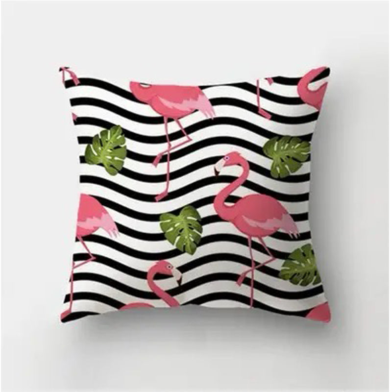 Decorative pillow cover featuring pink flamingos and green leaves over a black and white wavy stripe background.