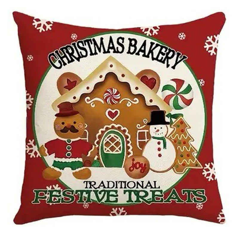 Christmas pillow cover featuring a gingerbread house, snowman and festive bakery sign with holiday treats.