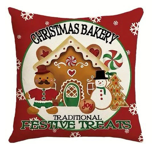 Christmas pillow cover featuring a gingerbread house, snowman and festive bakery sign with holiday treats.