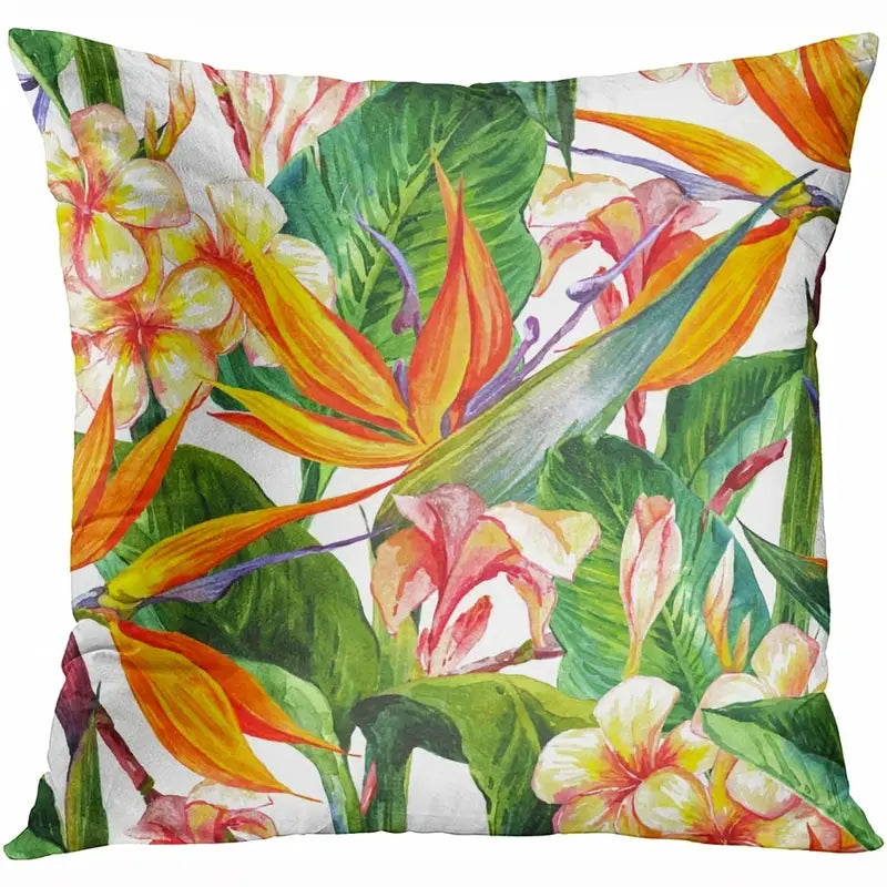 Decorative pillow cover featuring bird of paradise flowers, plumeria blooms, and green tropical leaves in orange, yellow, pink, and green tones.