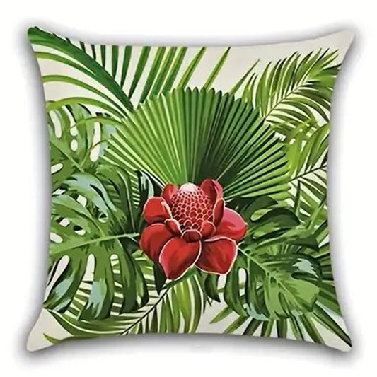Decorative pillow cover featuring a single red hibiscus flower centered among layered green palm leaves on a light background.