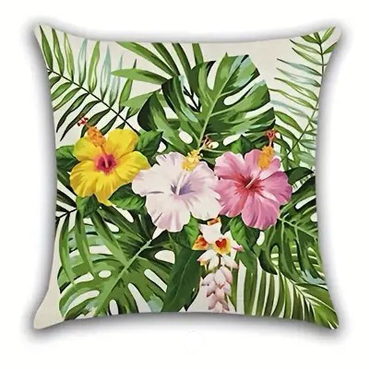Decorative pillow cover featuring three hibiscus flowers in yellow, white, and pink arranged across green palm leaves on a light background.