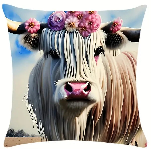 Square pillow cover featuring a close-up Highland cow portrait wearing a pink and purple floral crown against a soft sky background.
