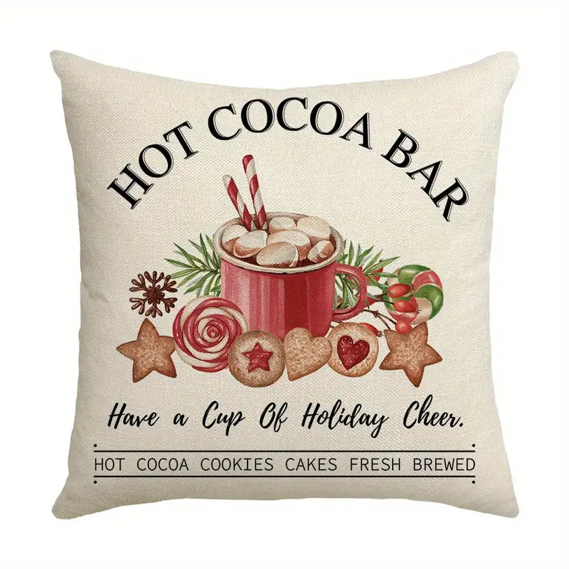 Pillow cover with hot cocoa bar text, a mug with marshmallows, cookies, and candy on a neutral background