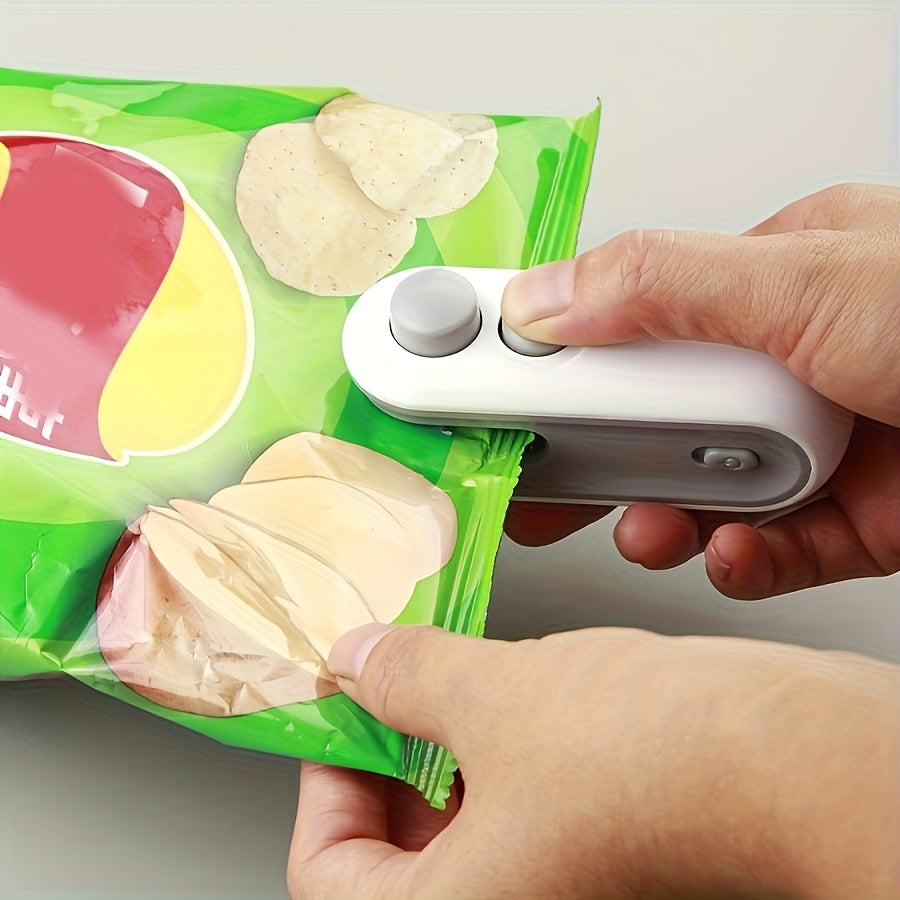 Innovative blue compact rechargeable portable vacuum sealer being used to seal a food bag for kitchen décor – Coastal Pillows Plus.