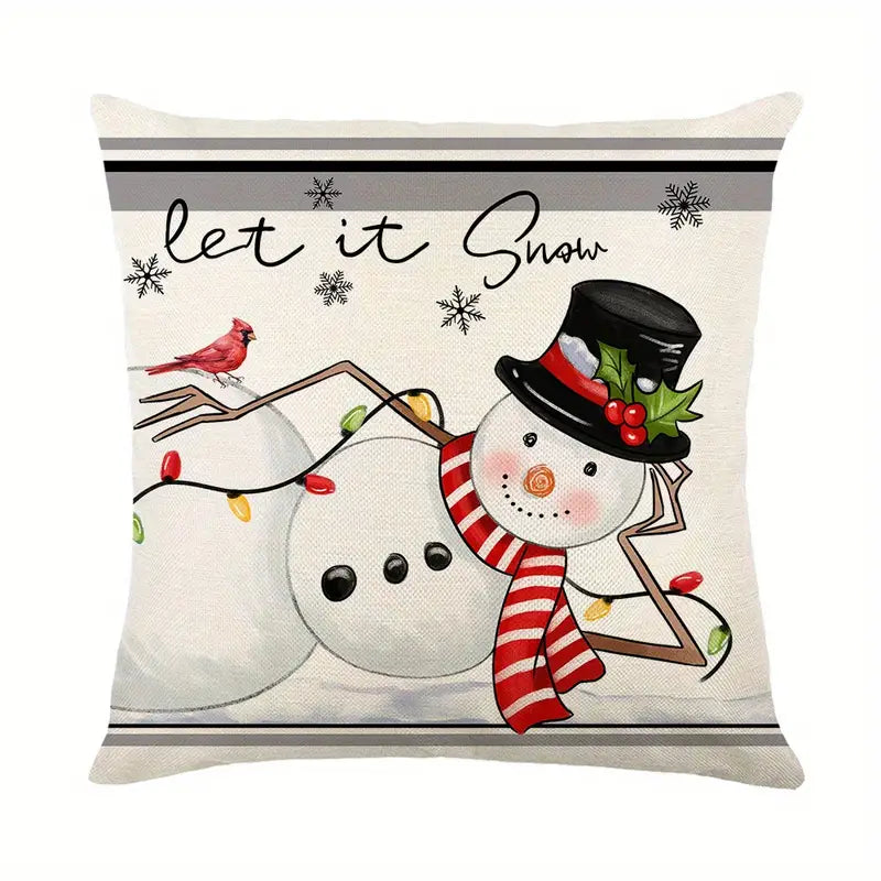 Linen pillow cover featuring a whimsical snowman with a red cardinal, festive lights, and "Let it Snow" typography for winter home décor - 18x18.