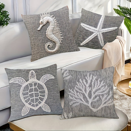 Coastal pillow cover collection featuring white seahorse, turtle, coral, and starfish illustrations on gray fabric.