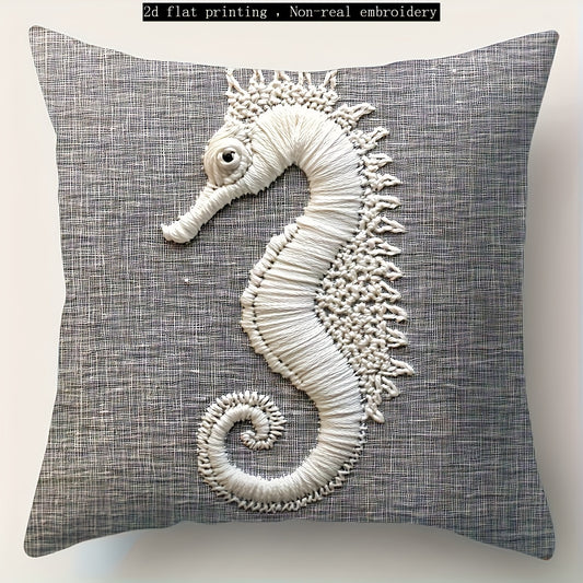 Gray coastal pillow cover with white seahorse illustration printed on woven fabric.