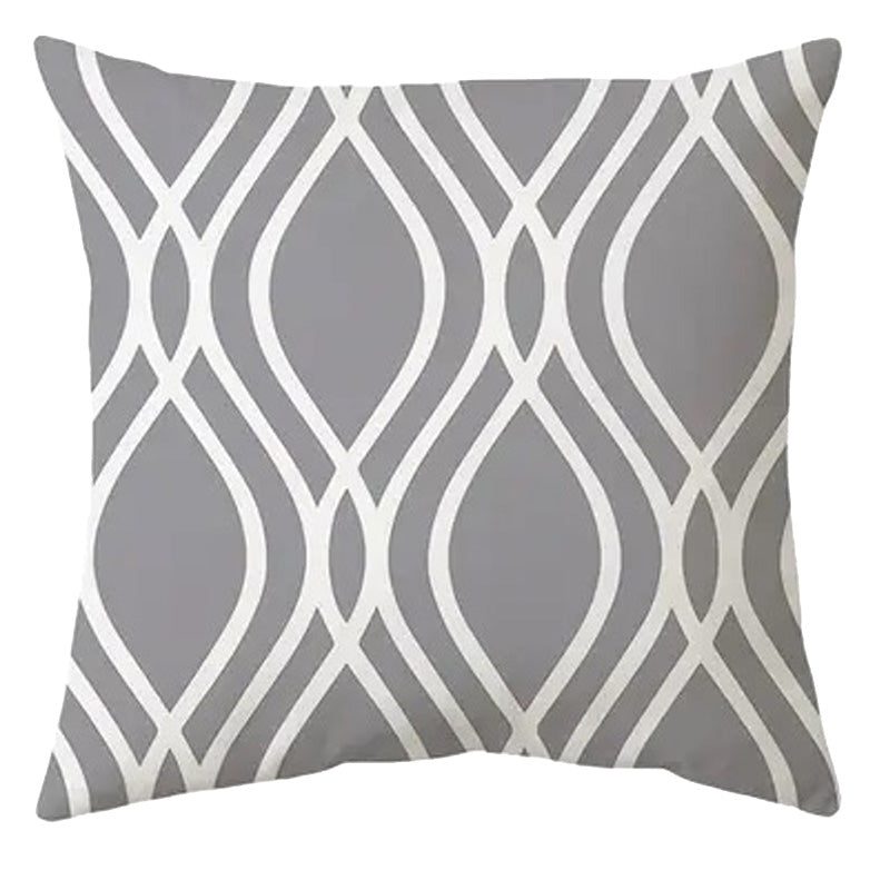 Modern 18x18 inch pillow cover featuring a bold white ogee wave pattern on a solid grey background, styled for contemporary living room décor – Coastal Pillows Plus.