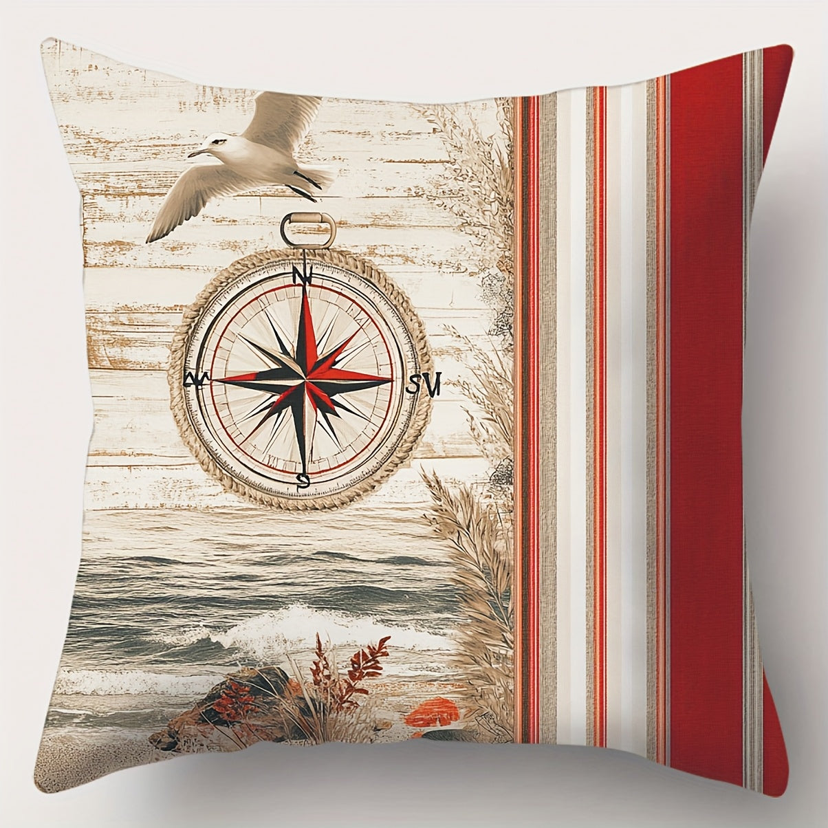 Square nautical pillow cover featuring a red, navy, and ivory compass design with coastal shoreline imagery and vertical stripe panel, hidden zipper closure.
